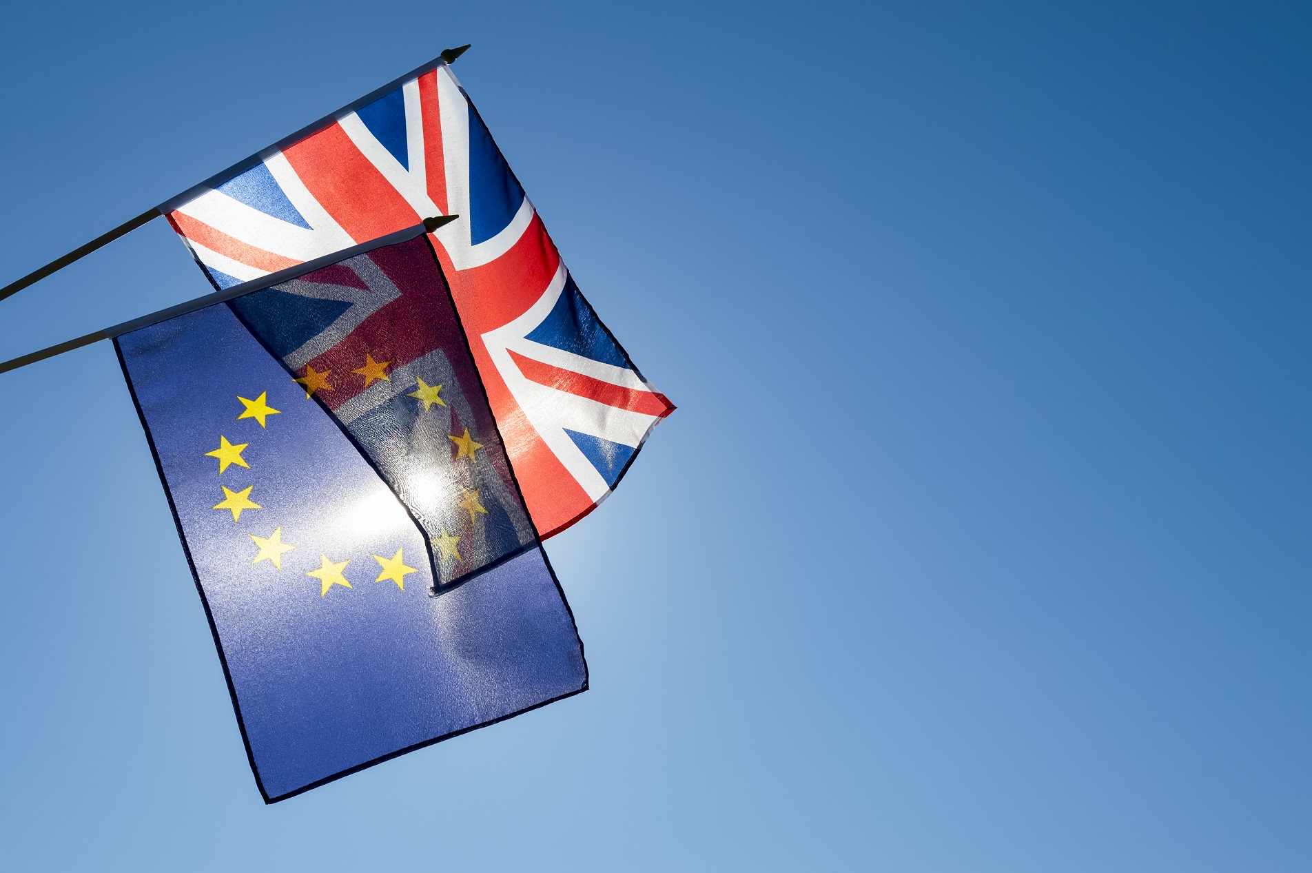 UK and EU flags in front of the sun
